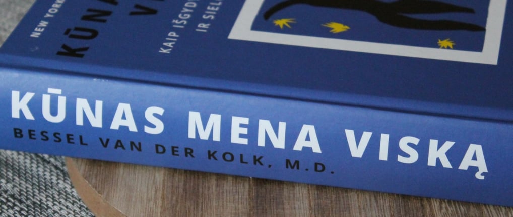 a book about a person with a book on a wooden table