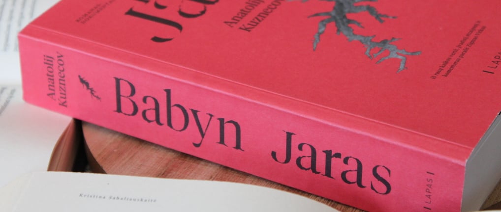 a book with a bookmark on it and a book on a table