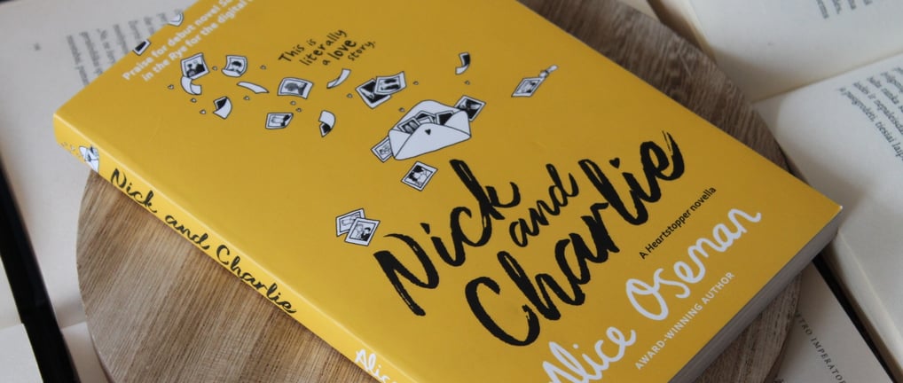 a book with a yellow book cover and a book on a wooden table