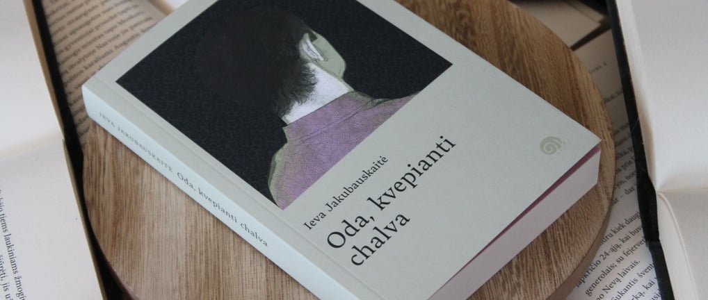 a book with a cat sitting on a wooden table