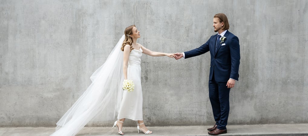 a bride and groom holding hands 