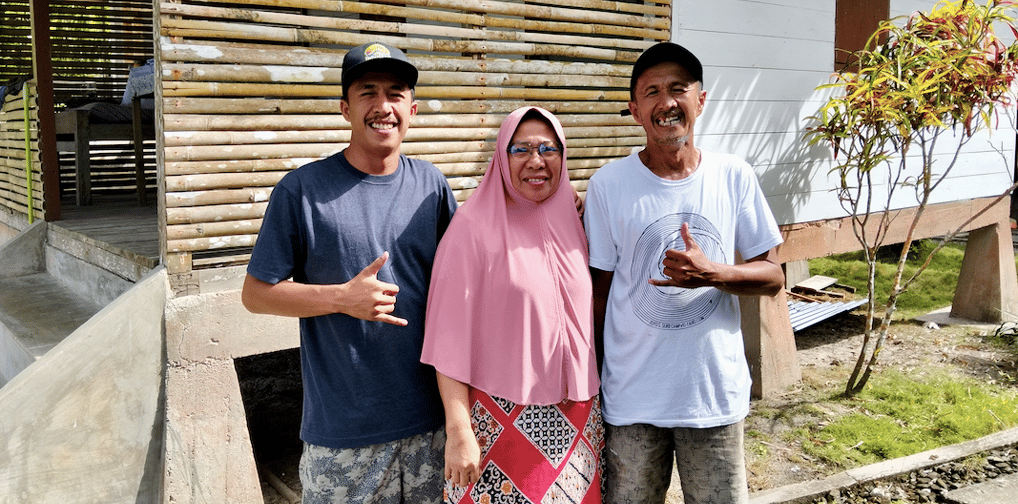 Family photo of the Afulu Surf Resort owners on the resort grounds.