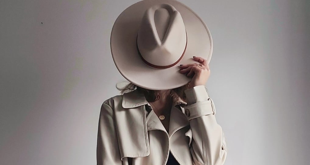 a woman in a hat on a white background