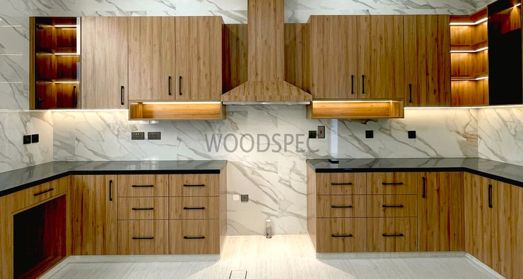 a kitchen with a marbled counter top and wooden cabinets