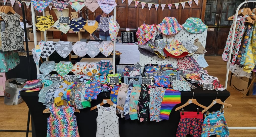 a table with clothes and clothes on it all handcrafted by distinctly individual