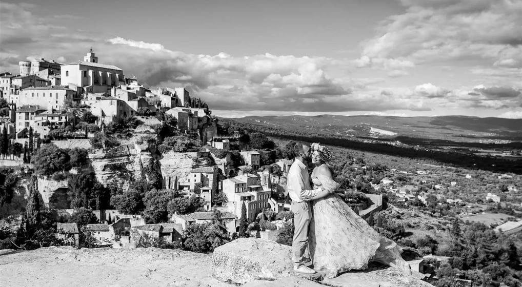 Editorial engagement photo – couple with stunning view of Gourdon village in the background