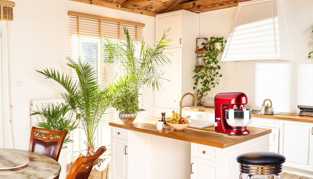 a kitchen with a red mixer and a table with a table and chairs