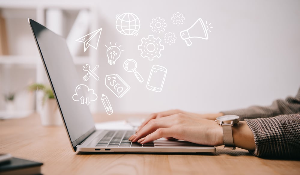 a person sitting at a desk with a laptop