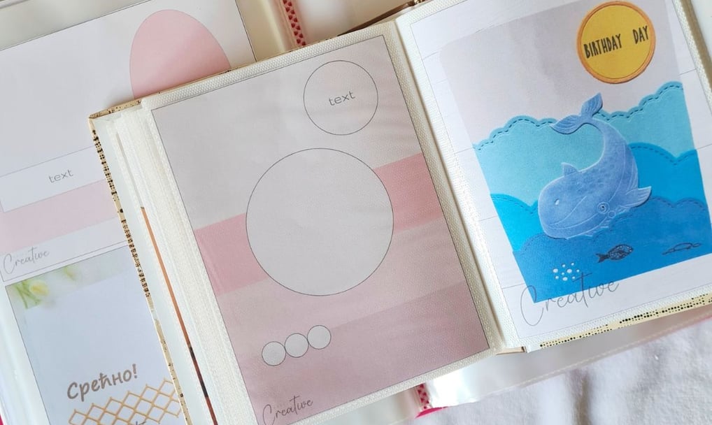 Open photo album with pastel-themed card making sketches. Left page has pink circles for text; right