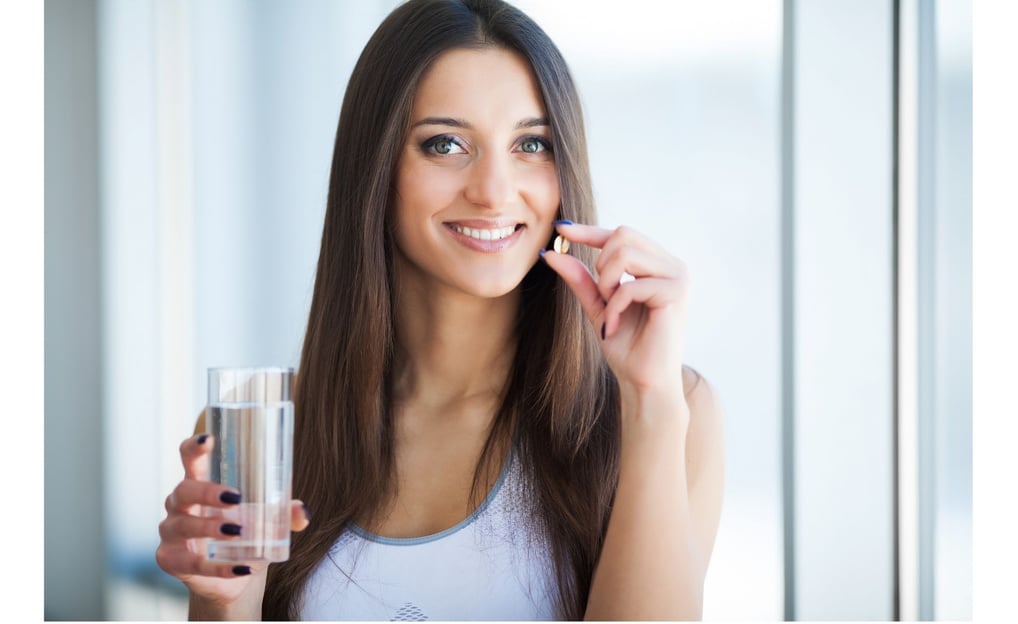 a woman holding a glass of water and a pill pill