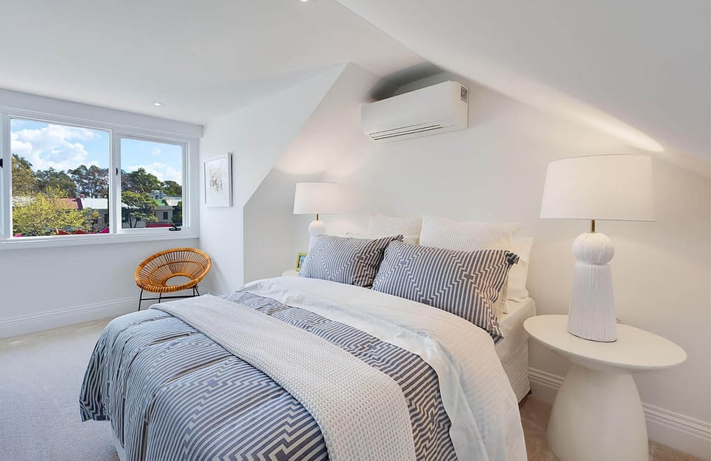 Bright attic bedroom interior with dormer windows, white color palette and minimalist design details