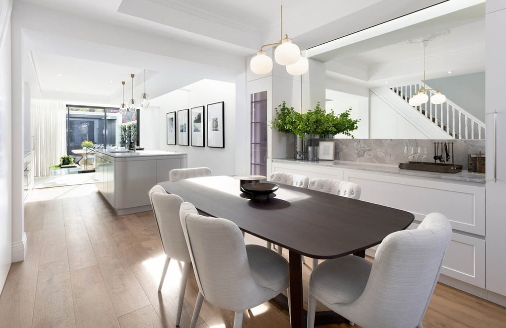 Modern dining room with custom joinery bar cabinets, oak flooring, dining table in renovated home