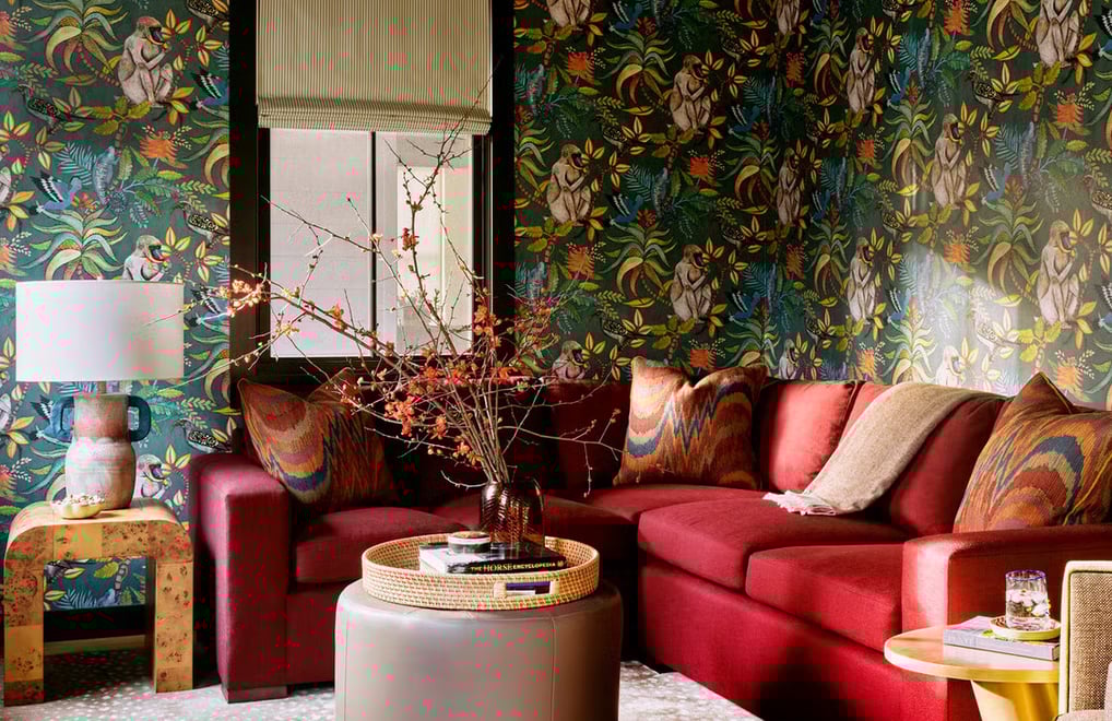 colorful living room, red couch, tropical wallpaper