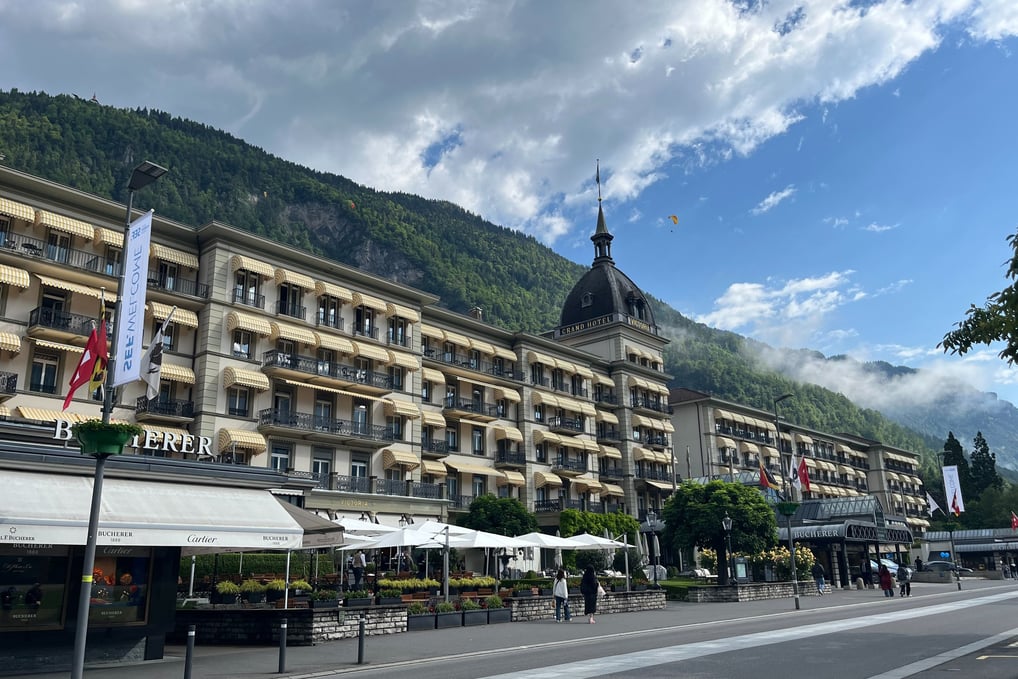 Victoria Jungfrau Hotel in Interlaken Switzerland with paragliders over head