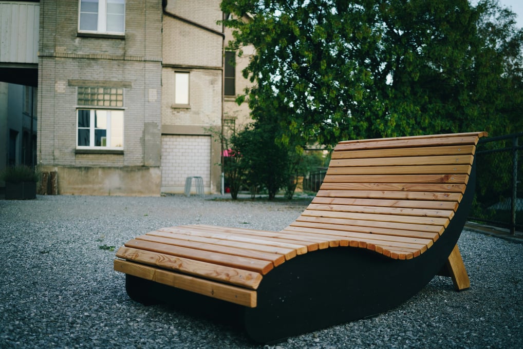 a wooden chaise lounger with a wooden bench and a bench