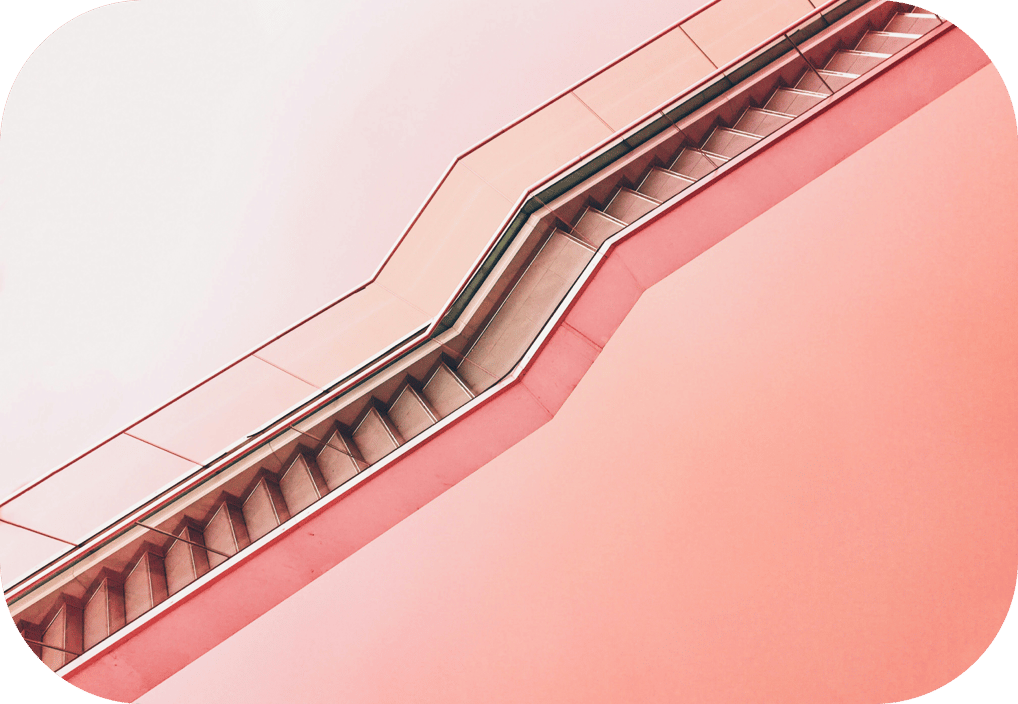 a staircase leading up to a building with a red sky background