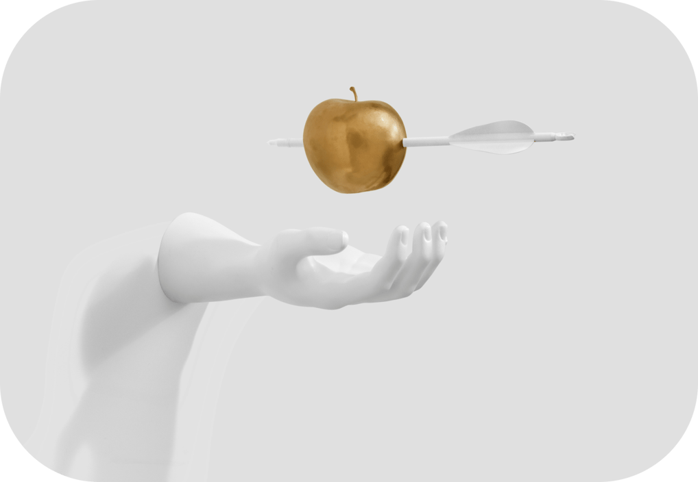 a person holding a golden apple in their hand