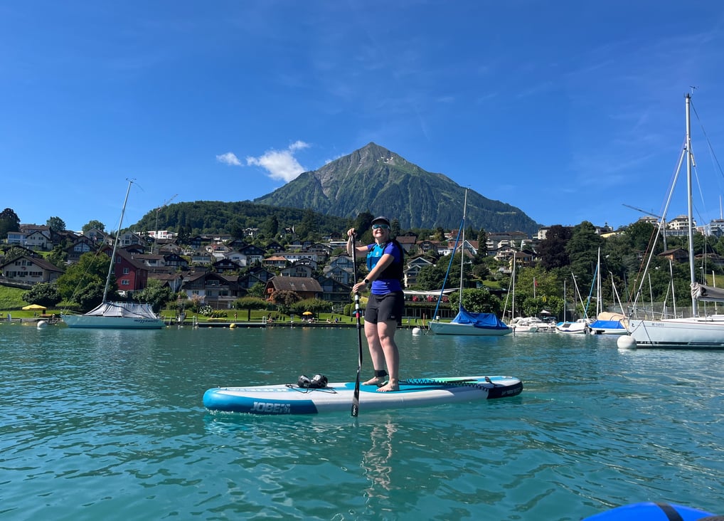 Corinne from Hidden Switzerland Travel Paddling in Spiez Bay