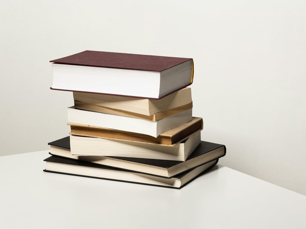 A stack of books used to show the folly of perfection