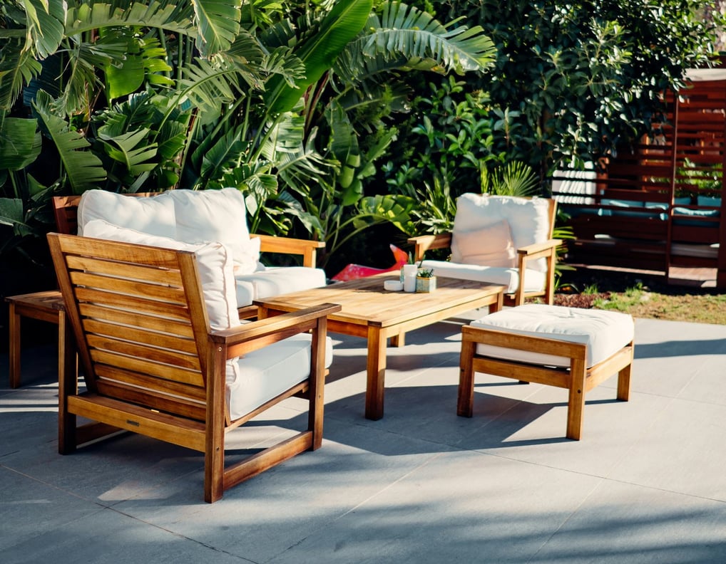 a patio with a wooden patio furniture set