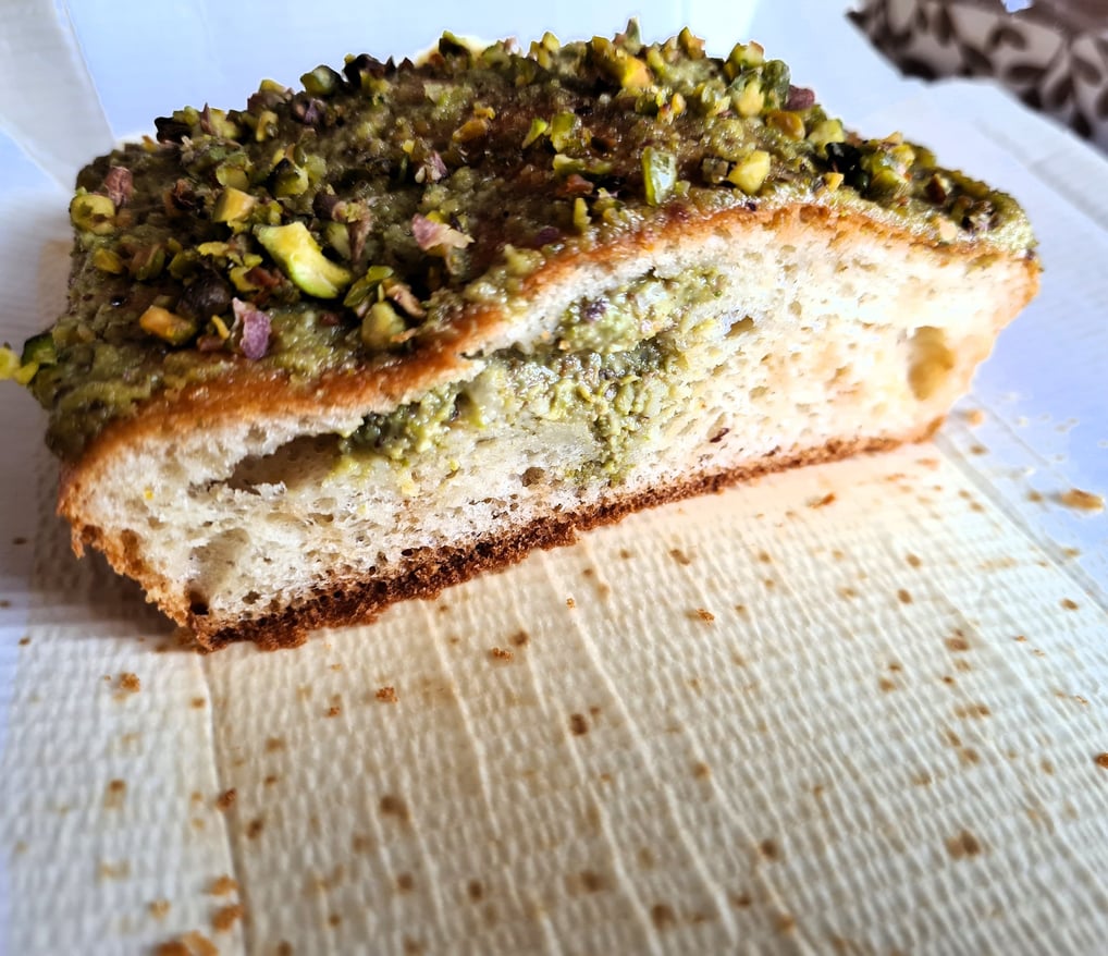 a piece of pistachio cake on the baking mold