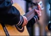 Moss.E playing guitar and busking in Kent
