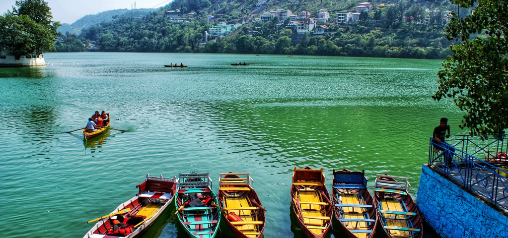 a group of people in a row boat on a lake