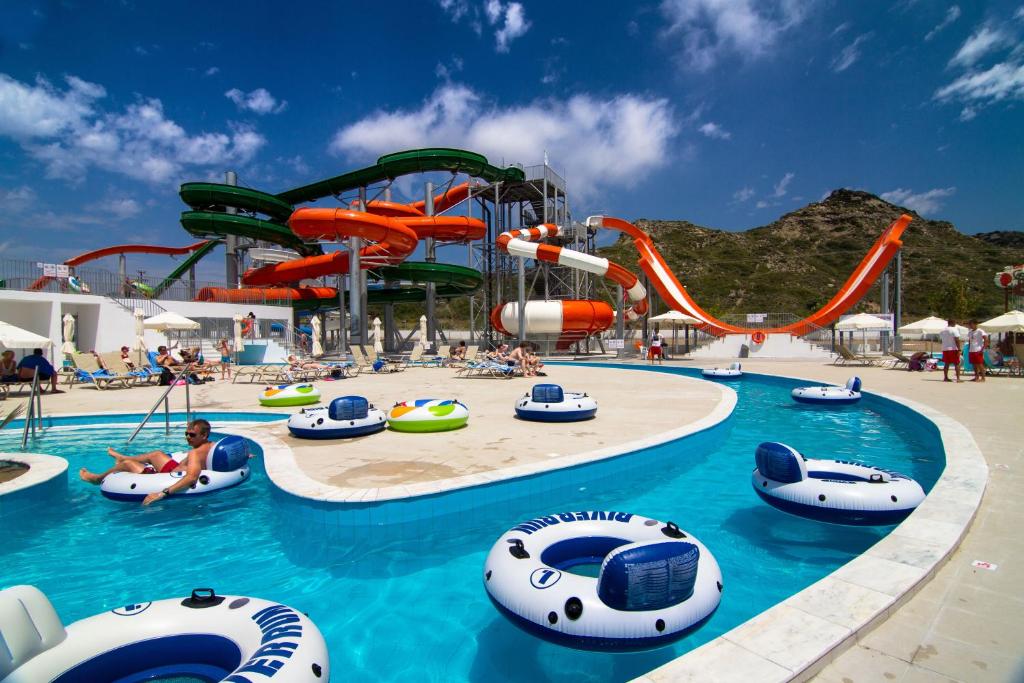 A sunny water park with a lazy river, inflatable tubes, and colorful twisting water slides.
