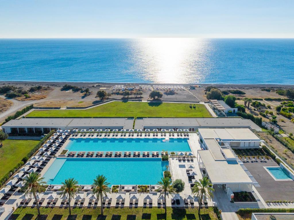 Aerial view of a luxury beach resort with large outdoor swimming pools and ocean views.
