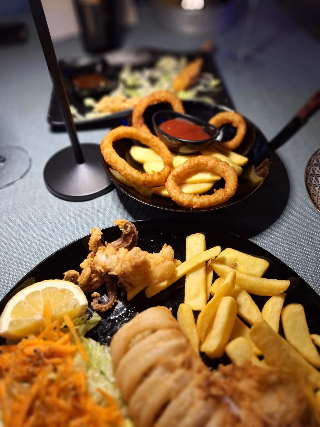 Crispy fried calamari and golden onion rings served with french fries, lemon, and dipping sauce.