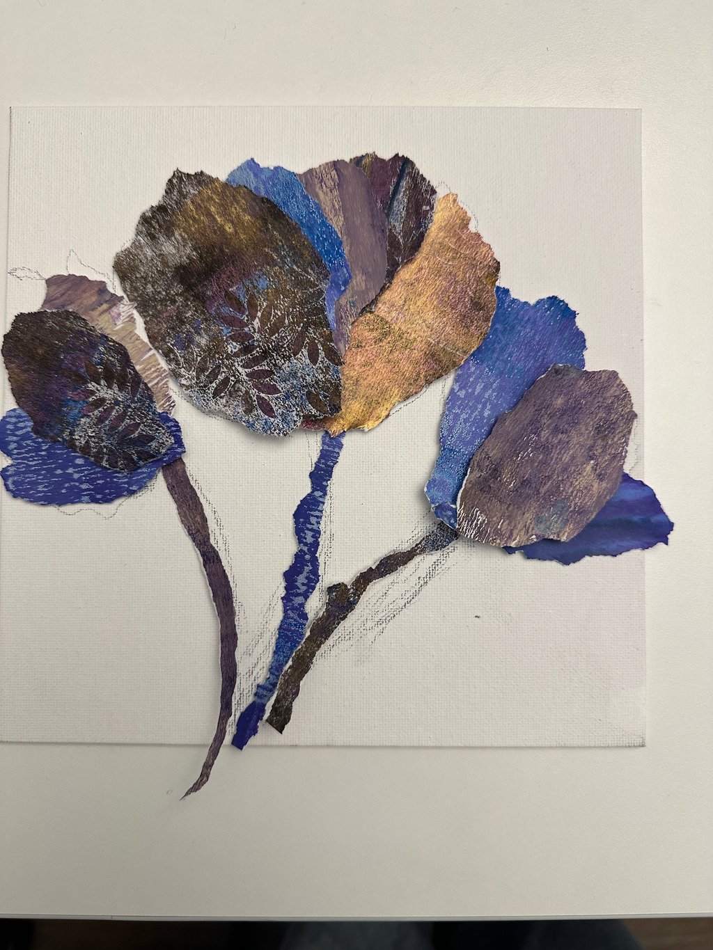 collage artwork featuring layered hand-painted papers forming botanical shapes