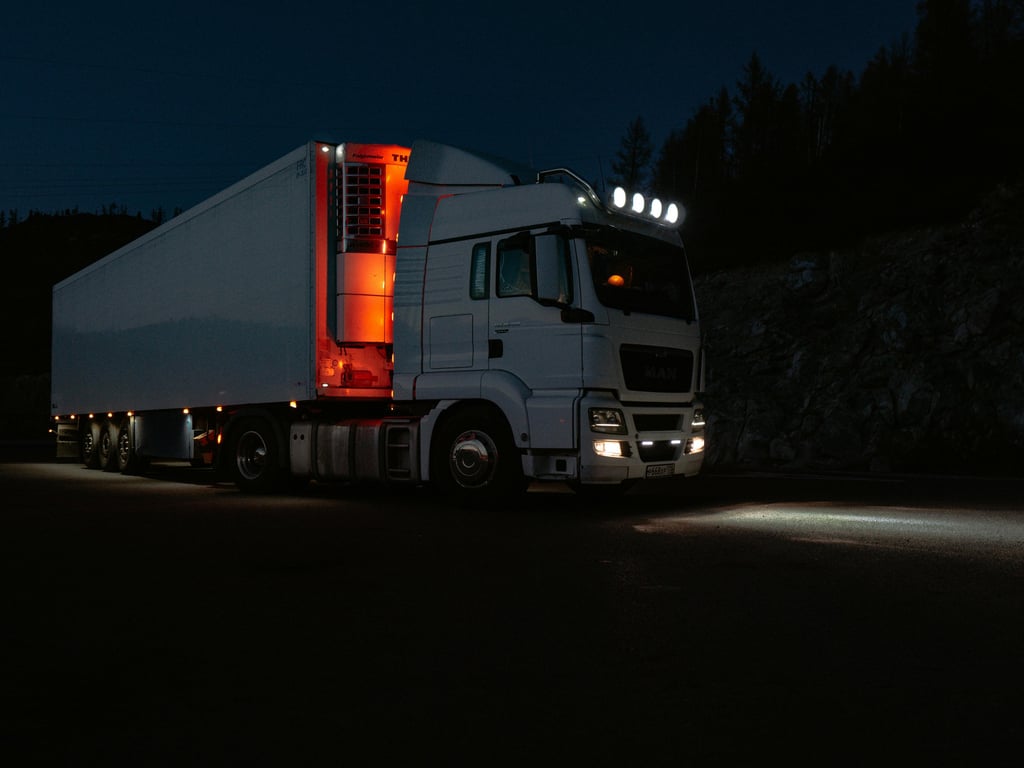 Mobile truck mechanic repairing semi truck breakdown on highway at night in Calgary Alberta