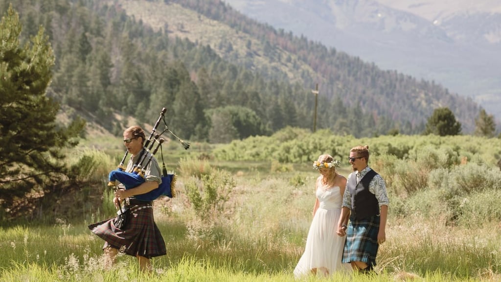 Couple with bagpiper in summer