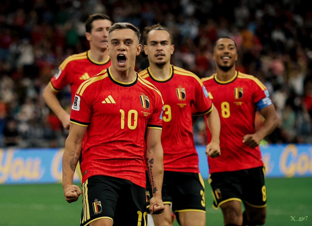 Leandro Trossard and Belgium national football team players celebrate a goal on the pitch.