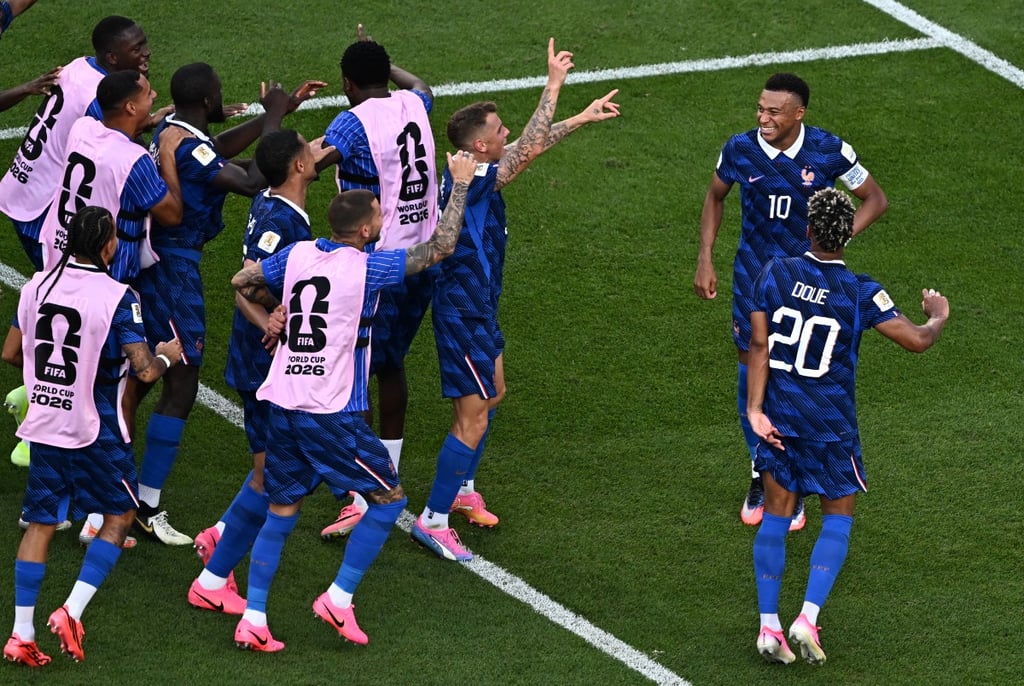 French national soccer team players celebrate a goal on the field during a FIFA World Cup 2026 match.