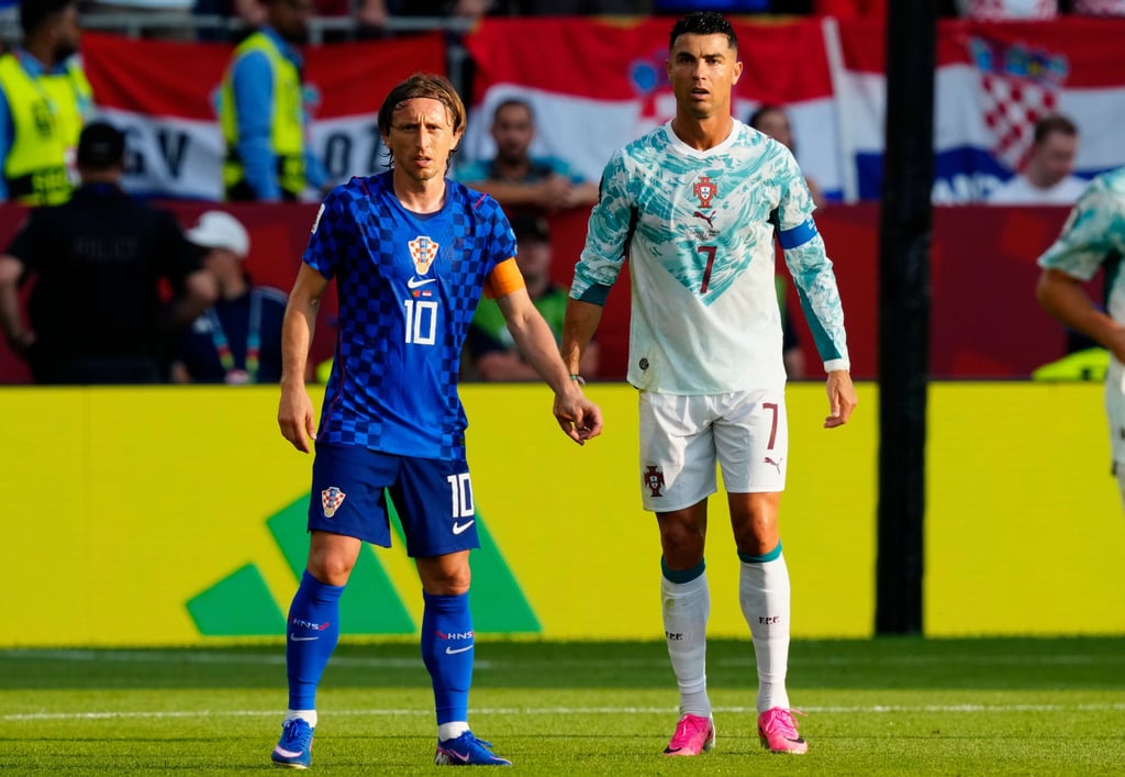 Luka Modric and Cristiano Ronaldo standing together during a Croatia vs Portugal international football match.