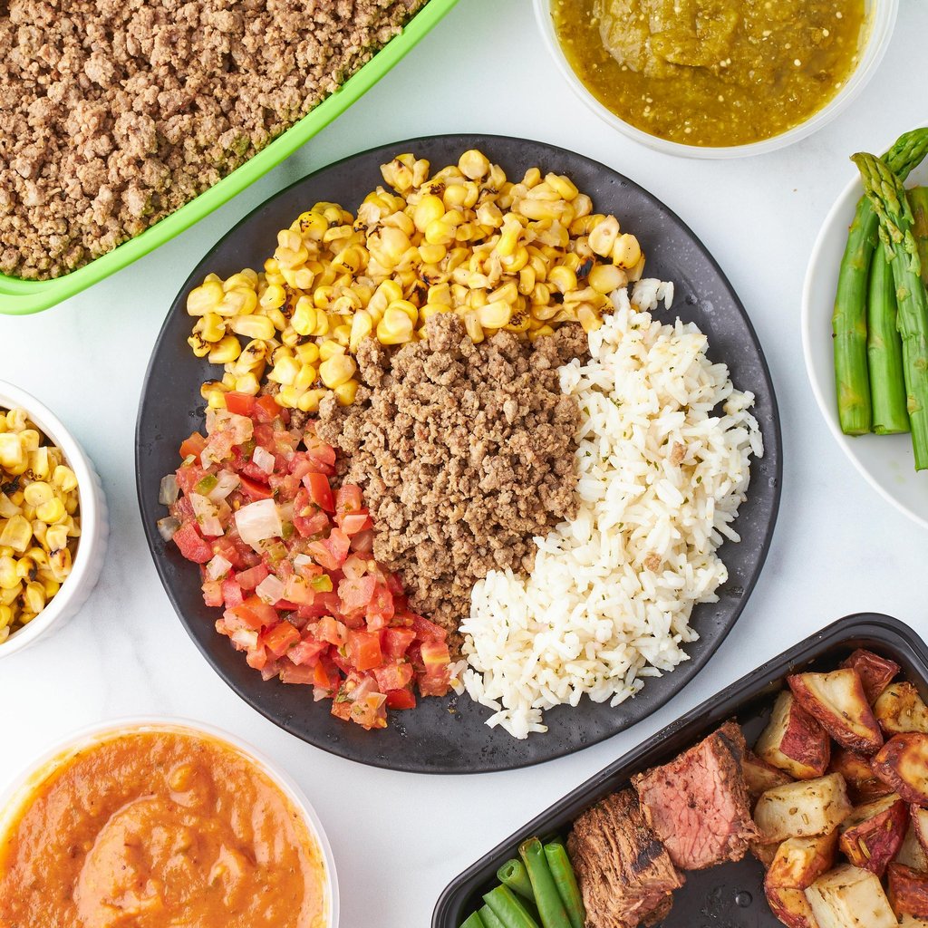 What I eat in a day for strength and hormone health — woman preparing healthy high protein meal — Fi