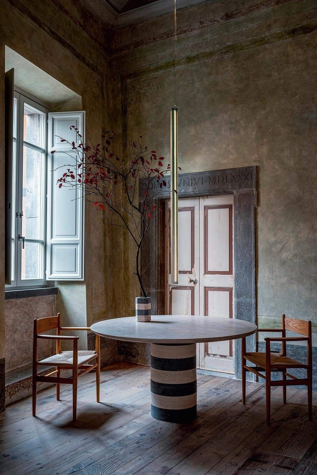 Custom basaltina and travertino table in the 15th century salone of Palazzo Petrvs, Orvieto. Photo Andrea Ferrari Studio.