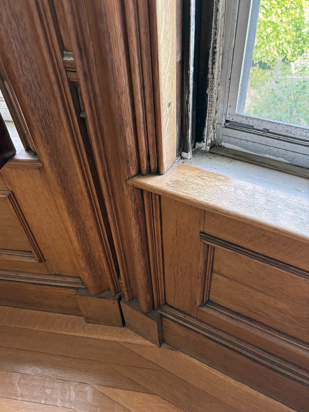 Original Italianate wood paneling and bow window millwork in a historic home in Harvard, Massachusetts.