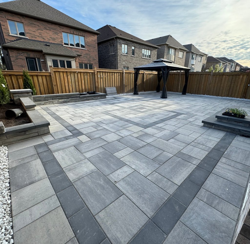Backyard hardscaping project in the Greater Toronto Area featuring modern stone patio and garden