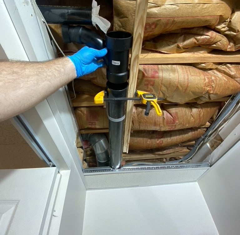 plumbing repair on a 3 inch drain line tee in basement ceiling with insulation