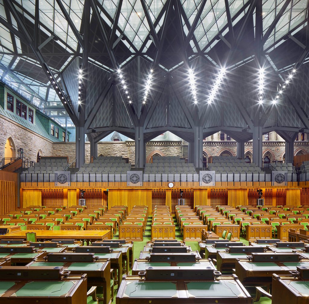 a large room with a lot of wooden tables and chairs