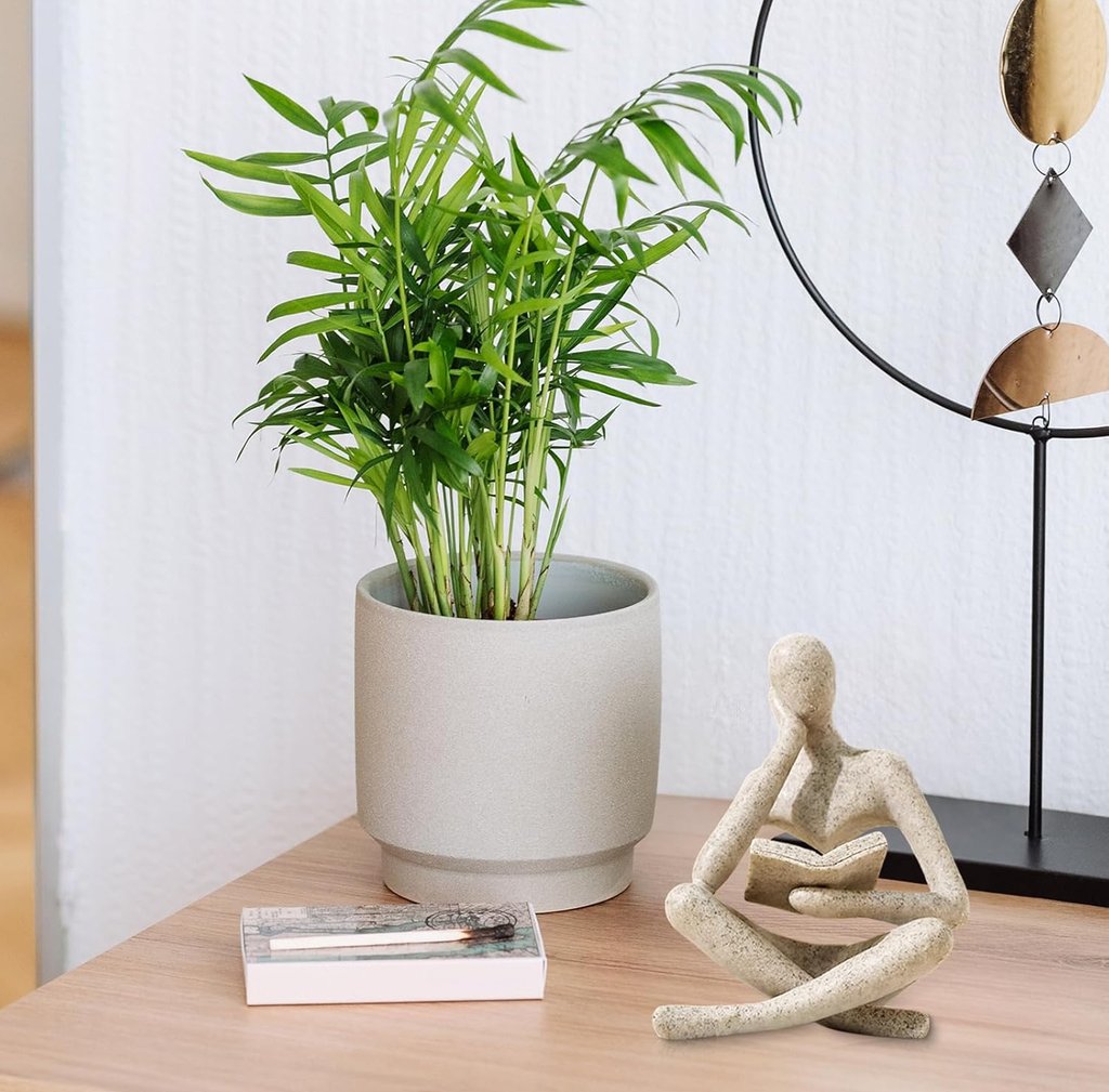 Thinker Statue styled with books and indoor plants on a small table for cozy home decor