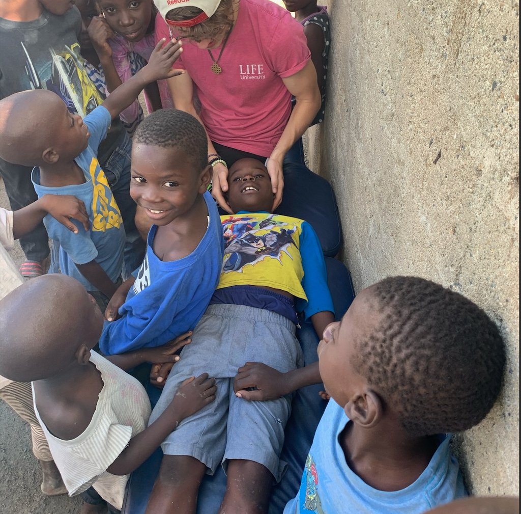 Dr. Spencer doing gentle pediatric adjustments an a faith trip to Haiti.