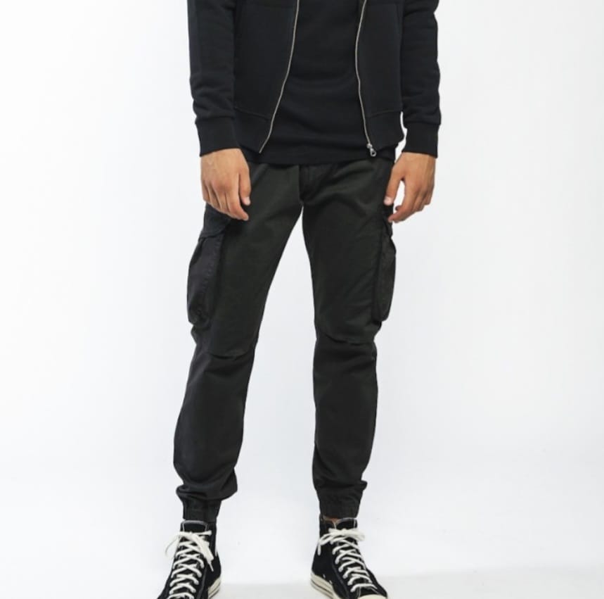 a man in a black hoodie and black pants