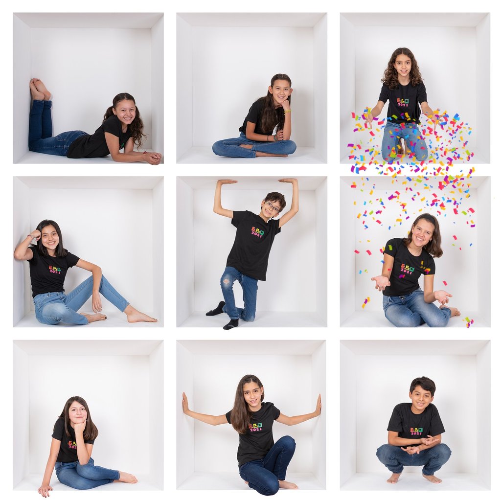 a woman in a black shirt and jeans sitting on a white wall