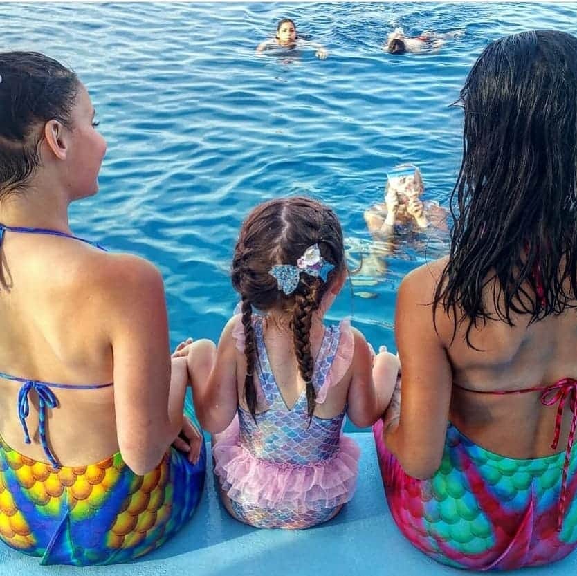 Mermaids entertaining children during a family boat tour in Protaras