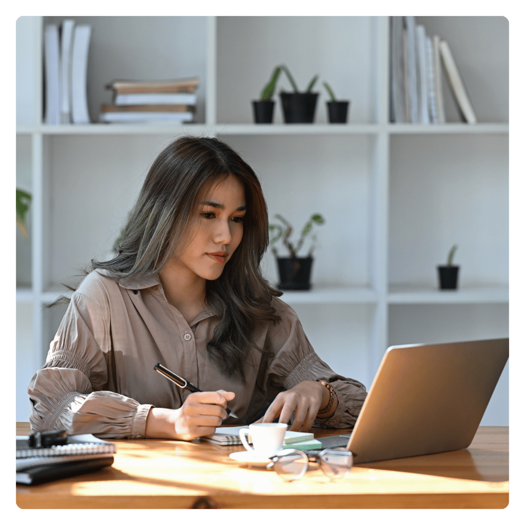 a computer user sitting at a desk learning new cybersecurity skills with Lümee awareness platform