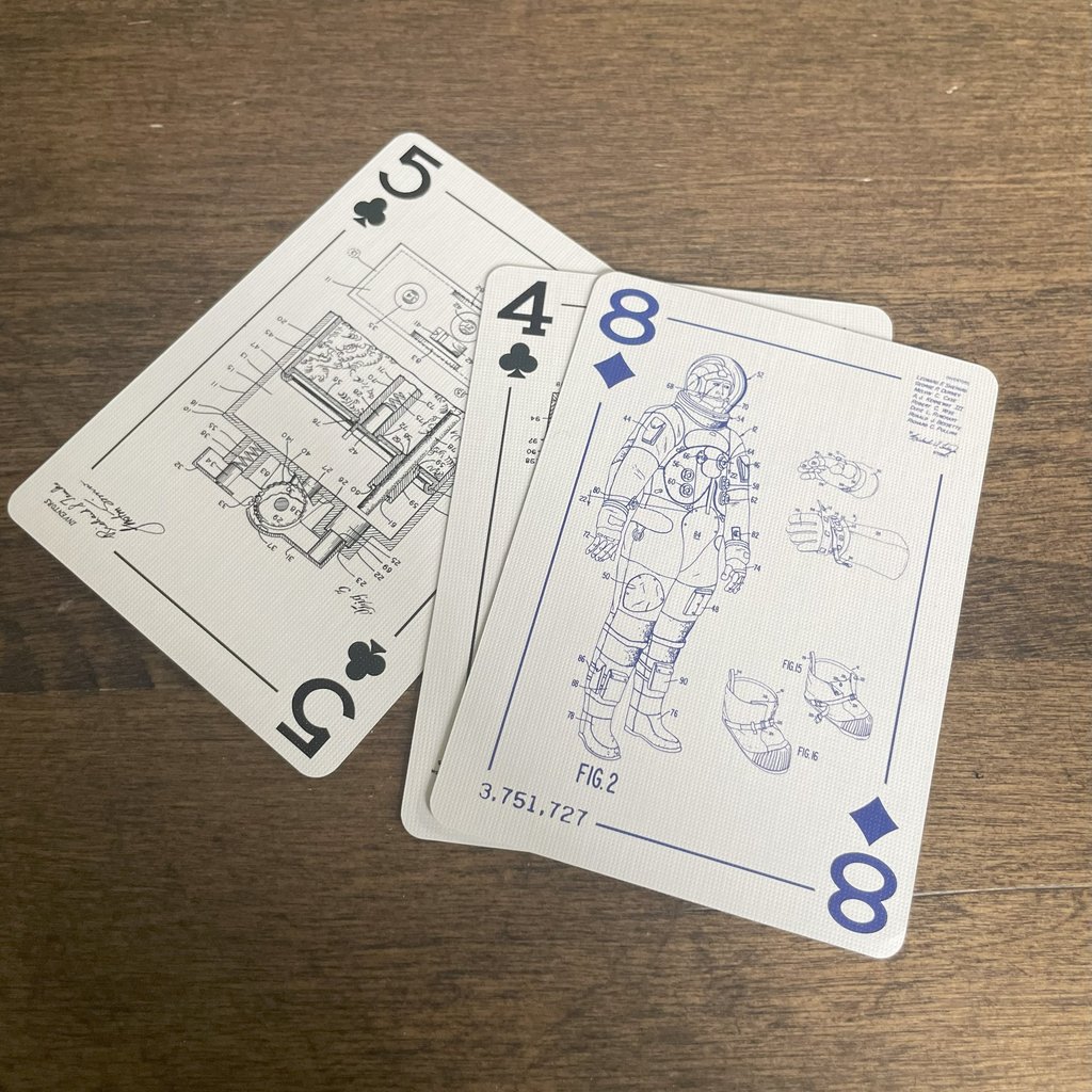 Five of Clubs, Four of Clubs, and Eight of diamonds showing engineering drawings from patents