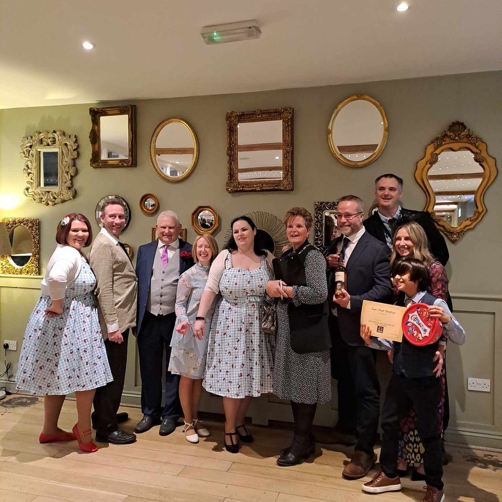 bride and groom with the cast and winners at the end of their wedding murder mystery